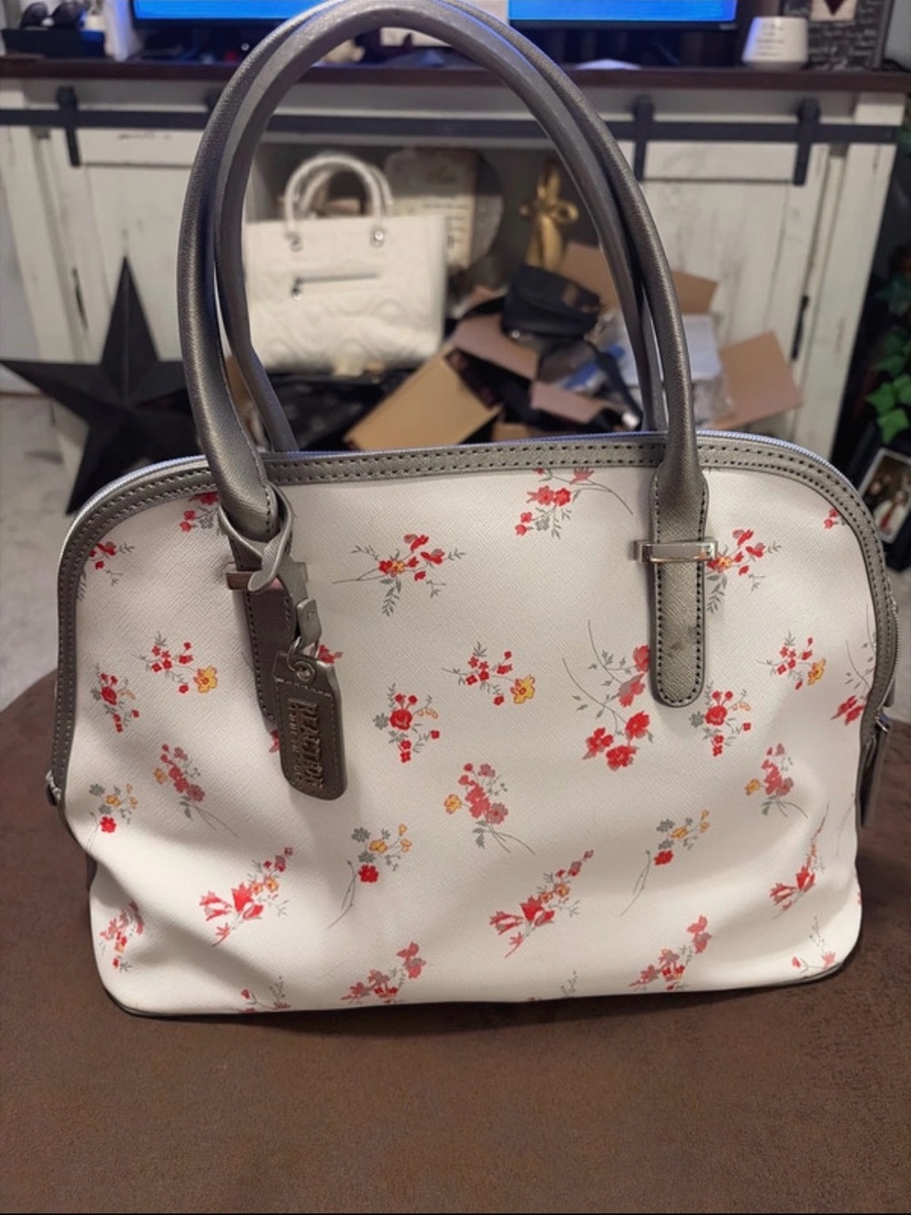 Kenneth Cole Reaction Satchel with white red and yellow floral accent.